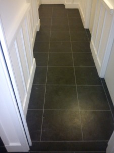 Here we have laid Black Slate Vinyl Tiles to hallway with grey grout strip to finish.