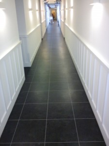 The completed Hallway looks modern and fresh with the black tiles and the grey feature strip to finish.